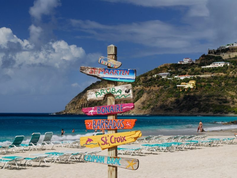 Signpost of Caribbean islands on the beach at St Maarten
